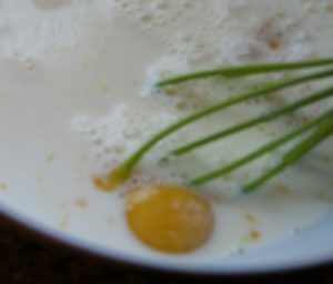 Whisk egg yolks and milk
